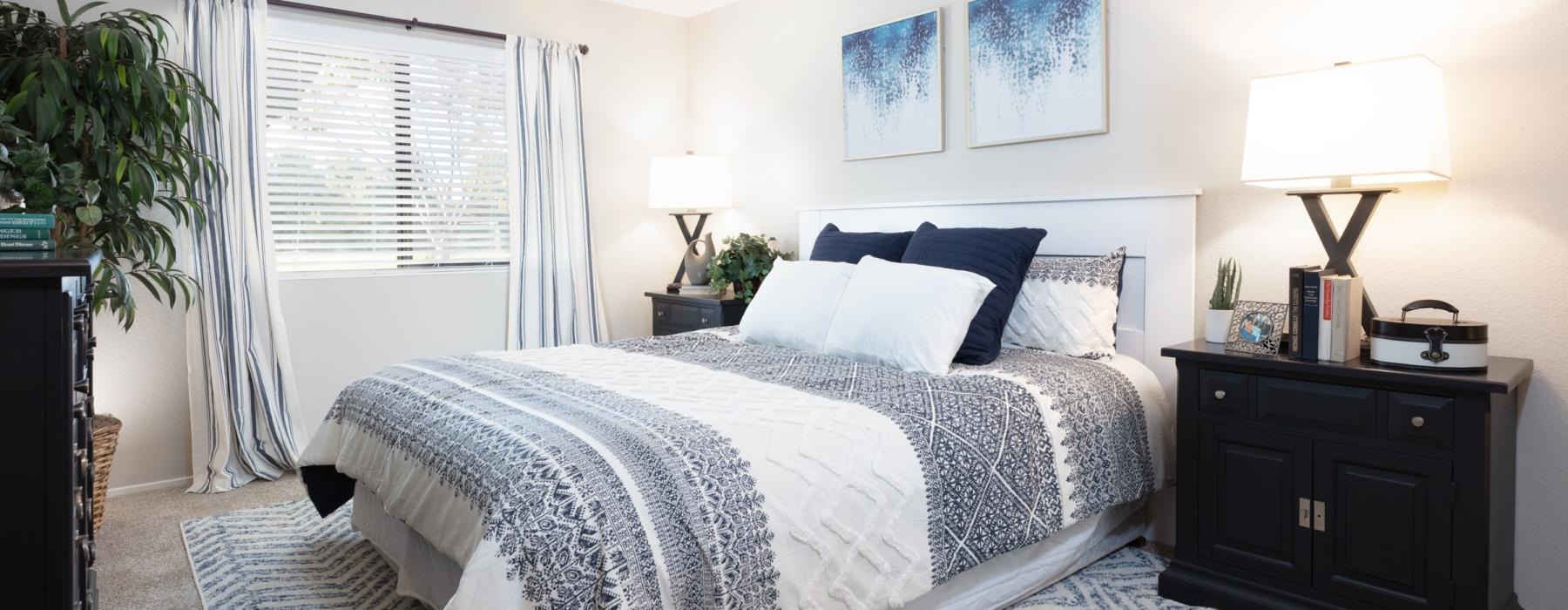 a bedroom with a bed and lamps