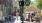 a couple of people walk down a sidewalk