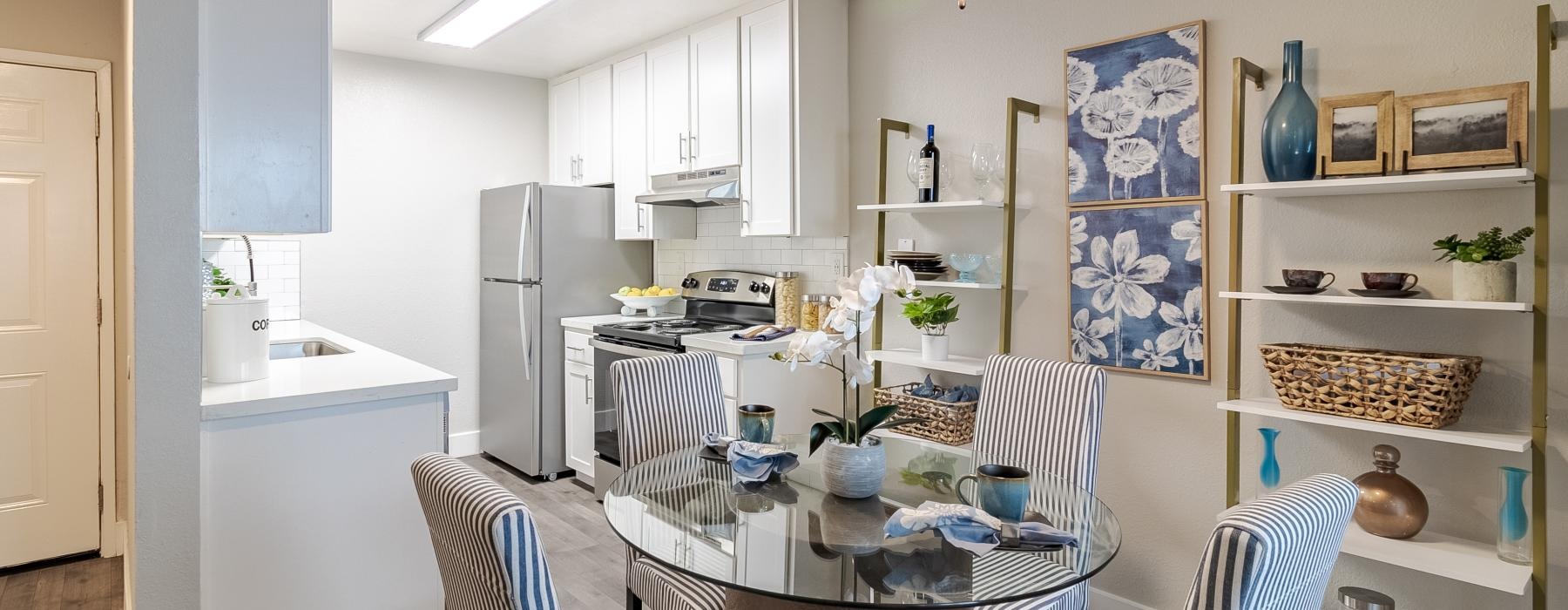 a kitchen with a dining table and chairs