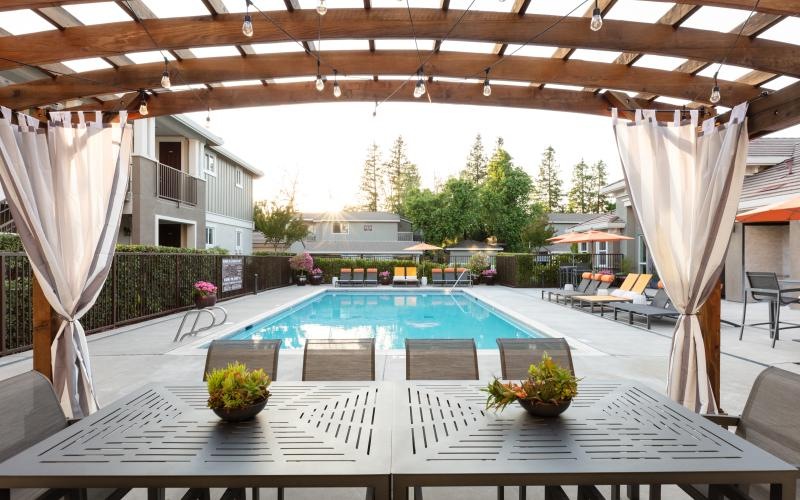 a swimming pool with a covered patio
