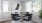 a dining room table with chairs and a painting on the wall